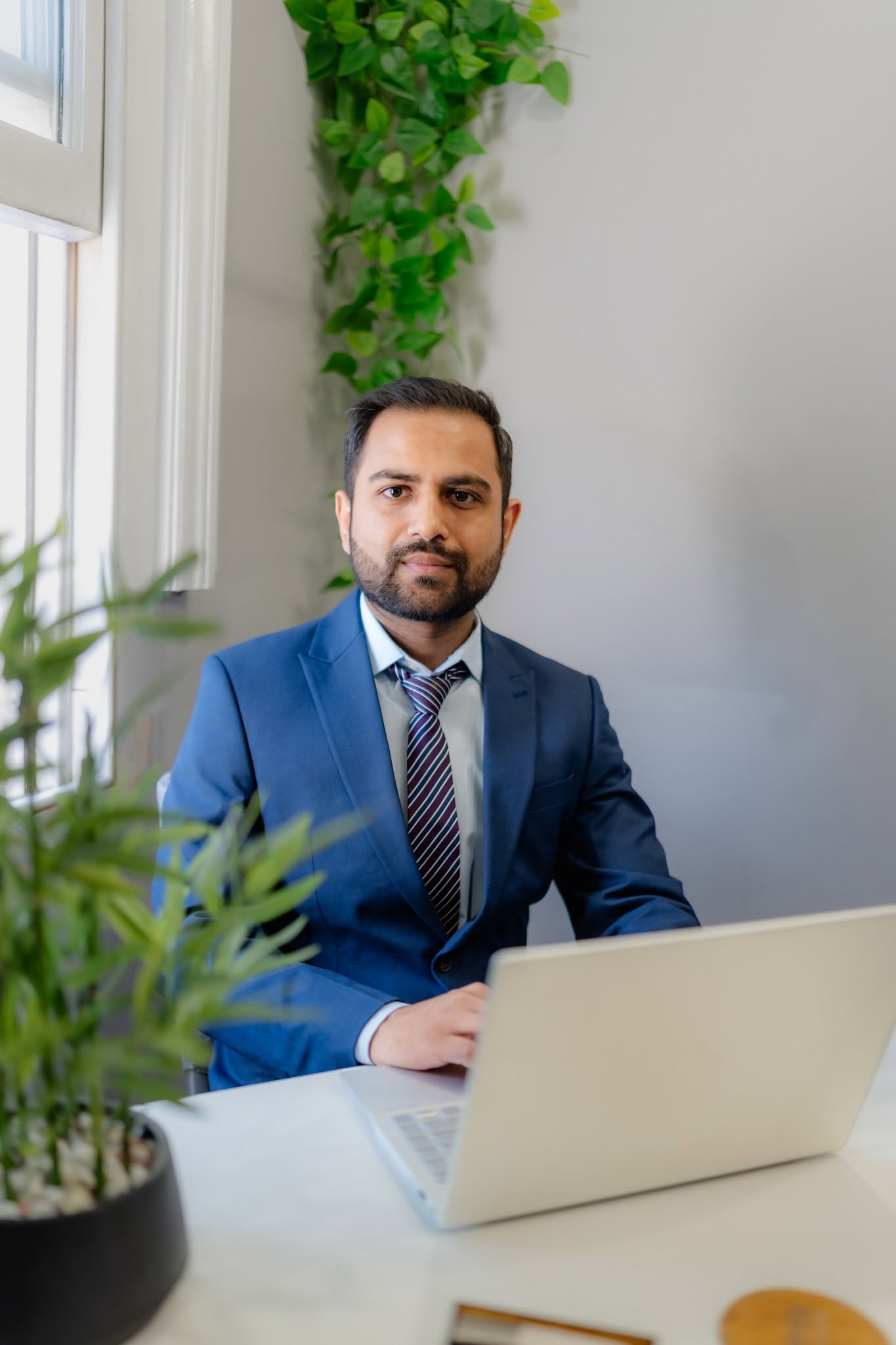Abrar Fahim working at his desk in London